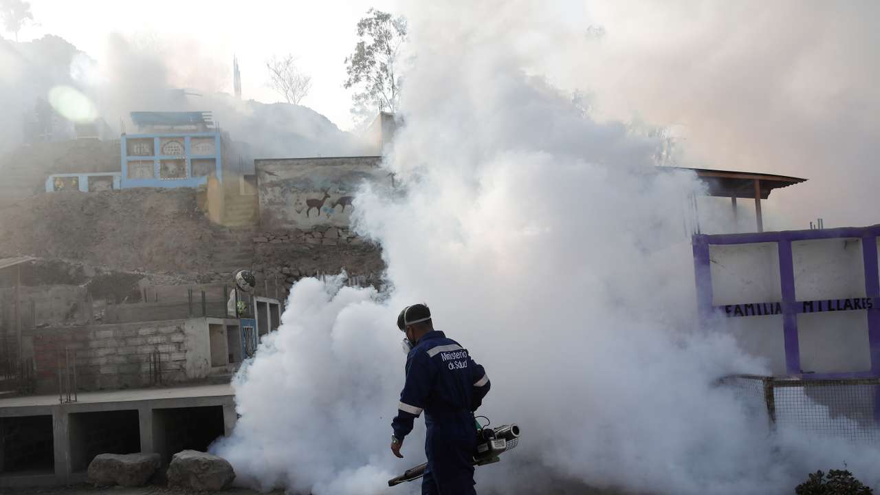 A health worker sprays fumigation vapour to stem the spread of dengue virus, in Lima