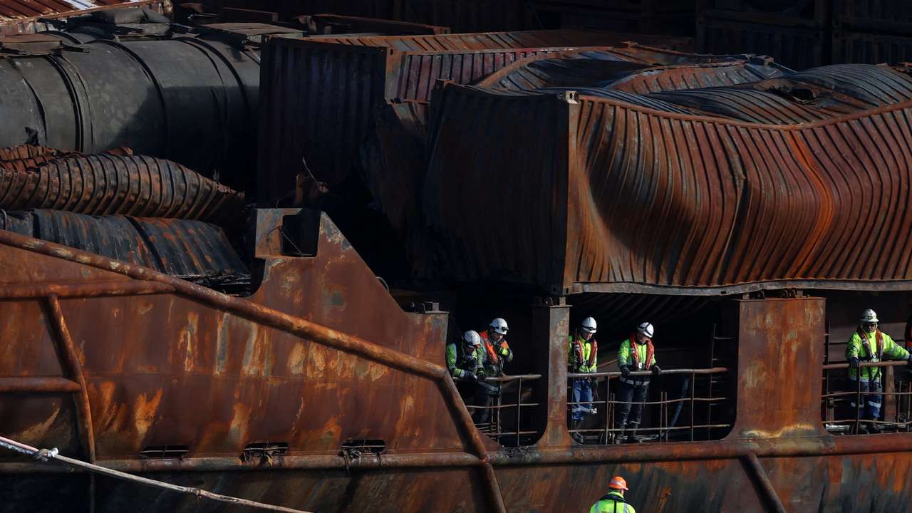 Salvage workers examine Solong container ship in Aberdeen