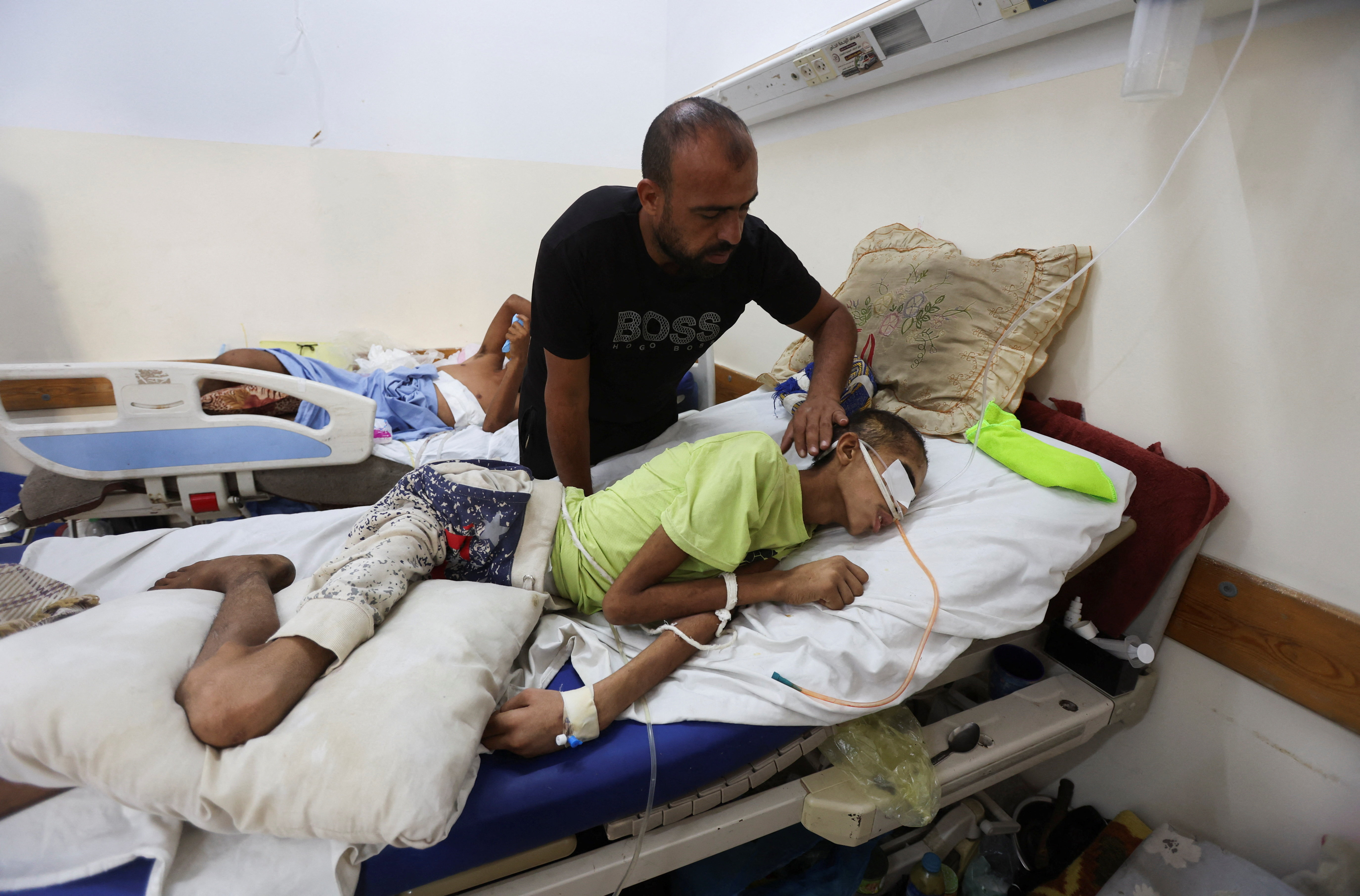 Gaza father hopes reopening of medical corridor can save his injured son in Khan Younis