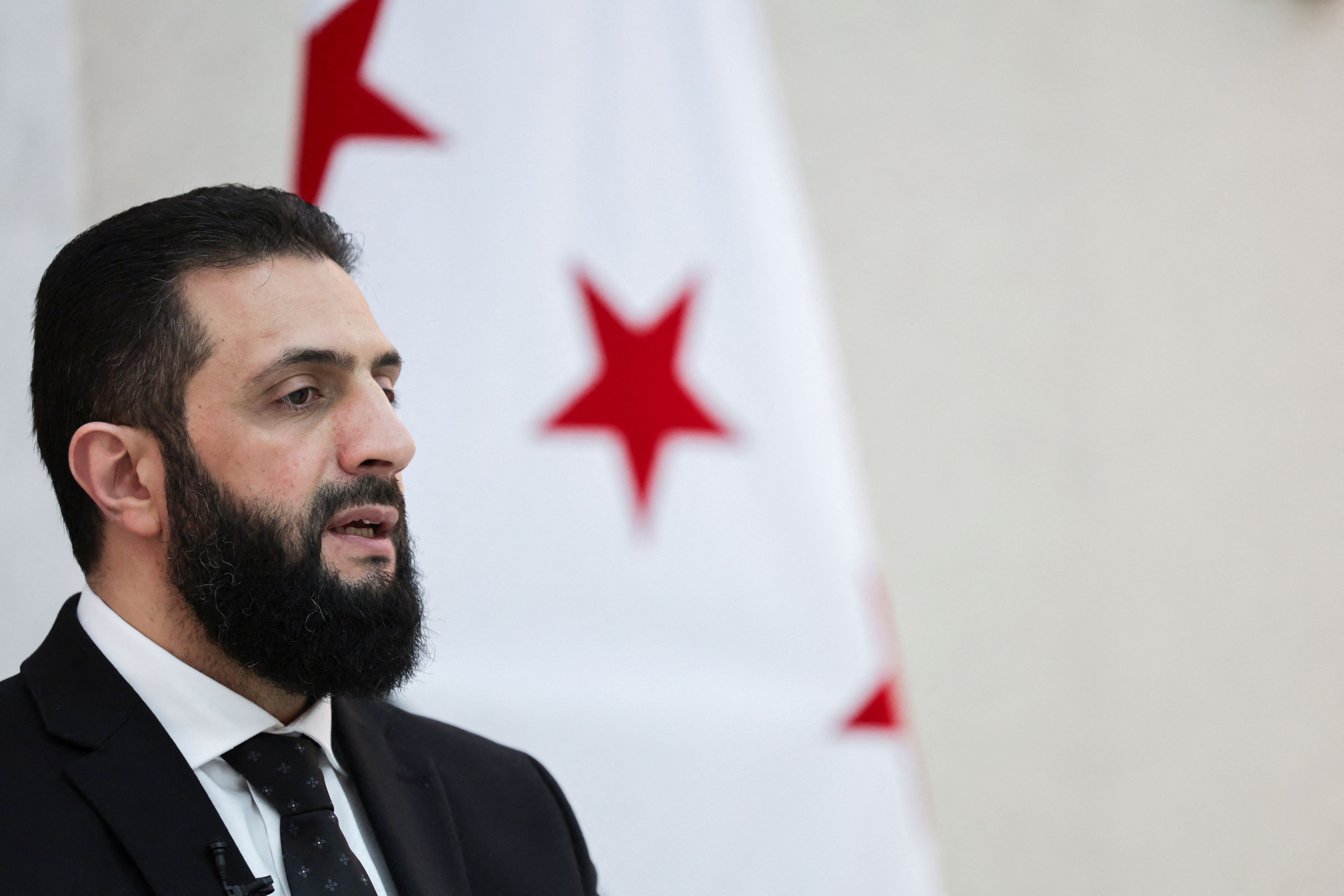 Syria’s interim President Ahmed al-Sharaa attends an interview with Reuters
