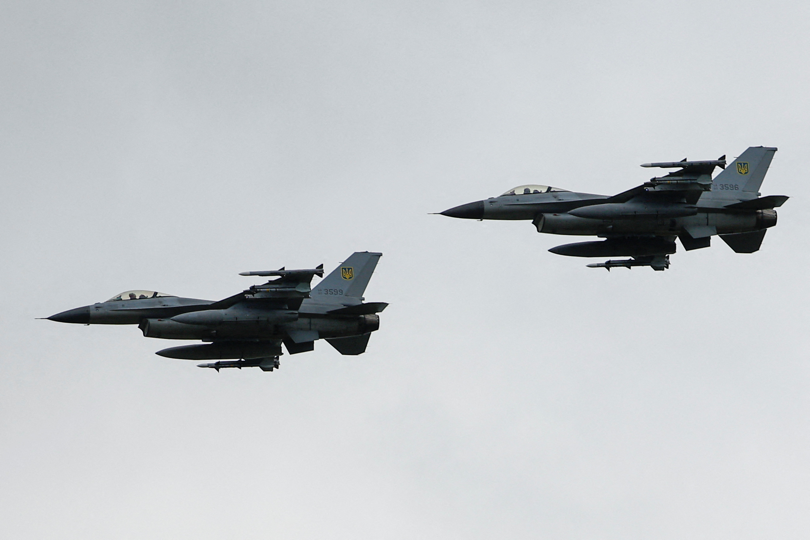 Ukrainian F-16 fighting aircrafts are seen in the air during marking the Day of the Ukrainian Air Forces in an undisclosed location in Ukraine