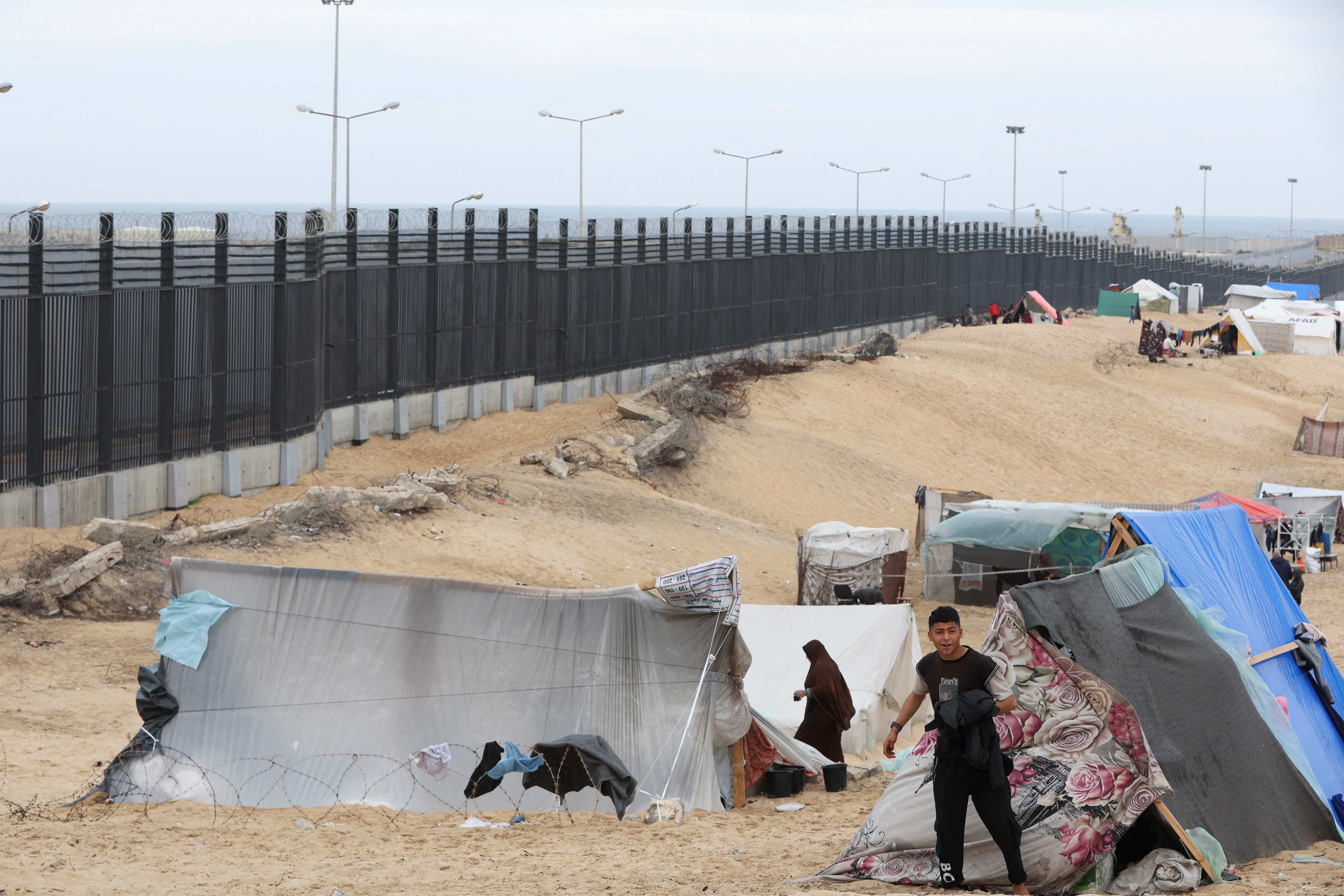 Palestinians shelter at the border with Egypt, amid fears of an exodus of Palestinians into Egypt, as the conflict between Israel and Hamas continues, in Rafah southern Gaza Strip