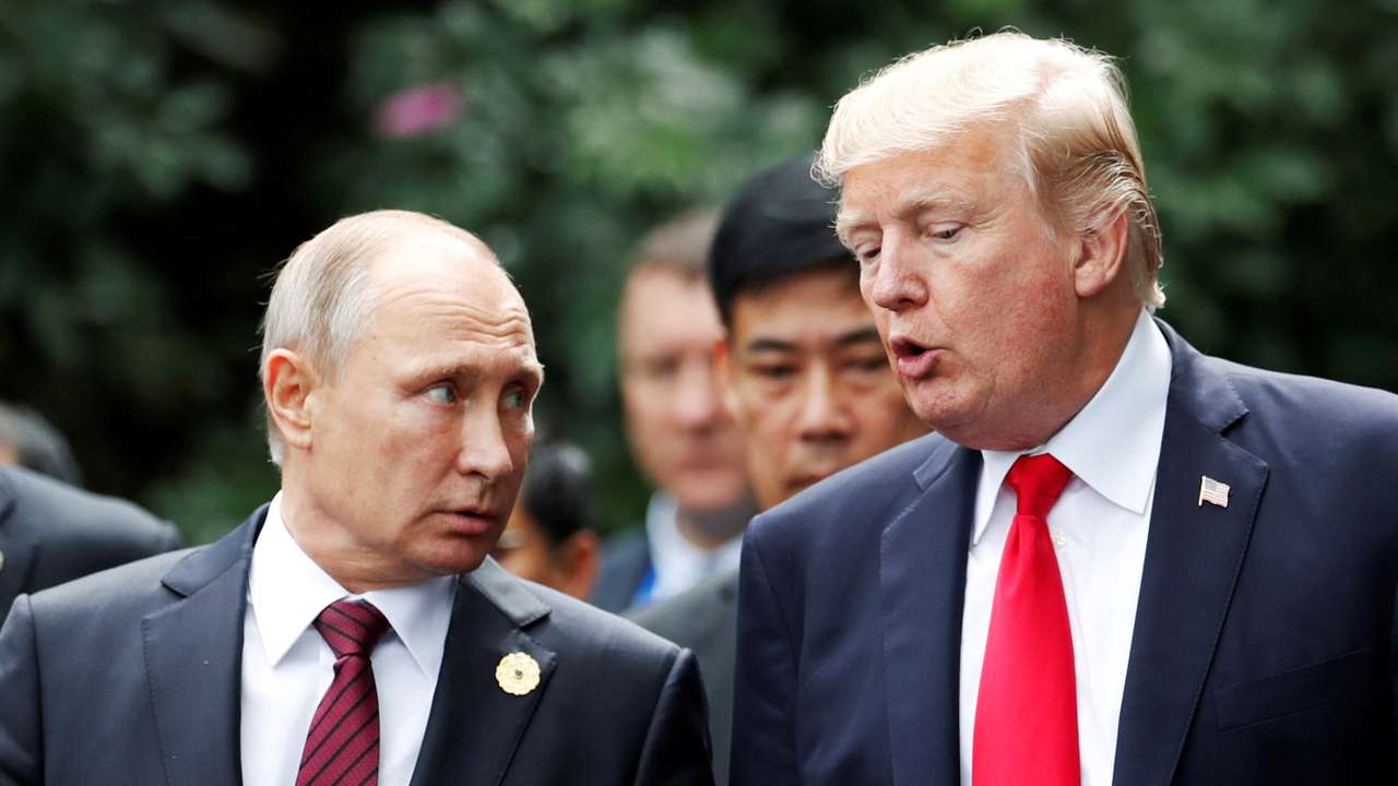 FILE PHOTO: U.S. President Donald Trump and Russia's President Vladimir Putin talk during the family photo session at the APEC Summit in Danang, Vietnam