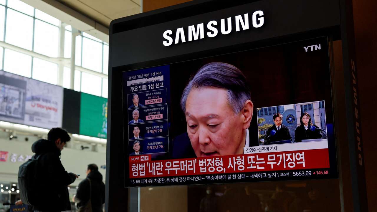 People watch a news report on the sentencing trial of South Korean former president Yoon Suk Yeol's insurrection case in Seoul