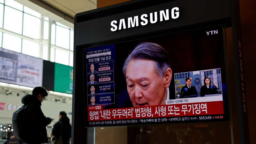 People watch a news report on the sentencing trial of South Korean former president Yoon Suk Yeol's insurrection case in Seoul