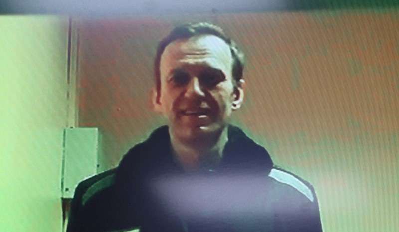 FILE PHOTO: Russian opposition leader Alexei Navalny is seen on a screen via video link during a court hearing in Moscow