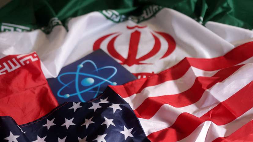 Illustration shows atomic symbol and USA and Iranian flags