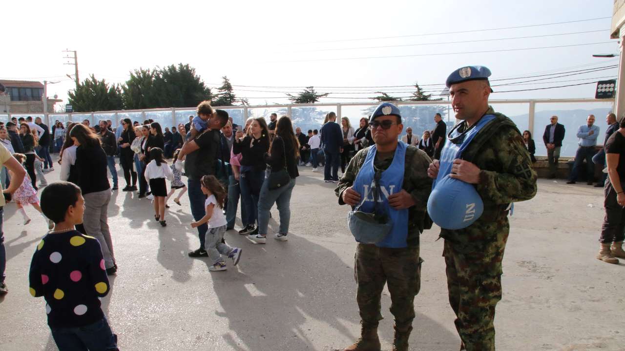 Members of the United Nations peacekeepers (UNIFIL) stand together at the church square on Good Friday in the town of Klayaa