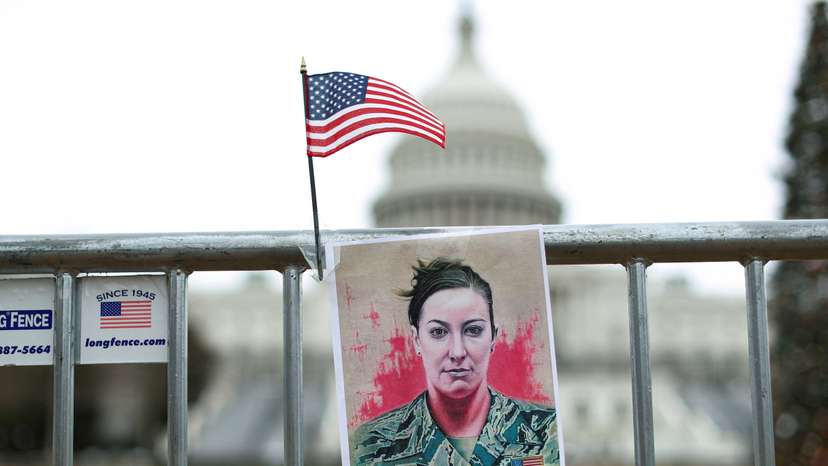 FILE PHOTO: A portrait of Ashli Babbitt hangs on a fence outside the US Capitol