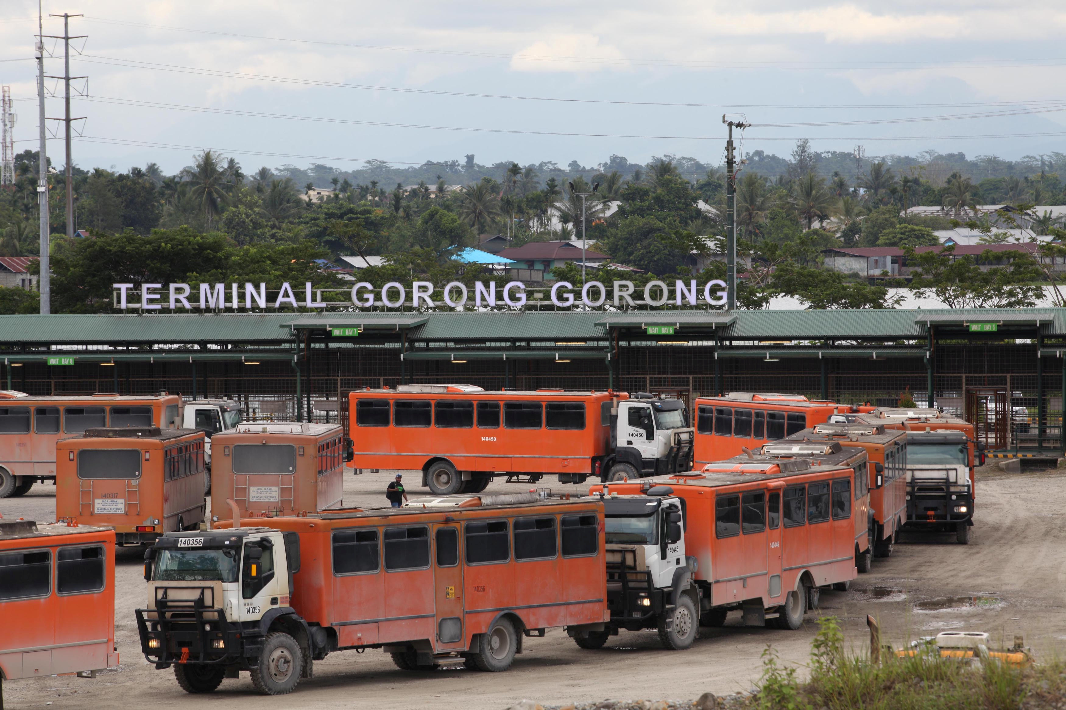 FILE PHOTO: Vehicles used for transporting workers to the Grasberg copper mine operated by Freeport McMoRan Inc are seen at the Gorong-Gorong terminal in Timika, Mimika, Papua province,