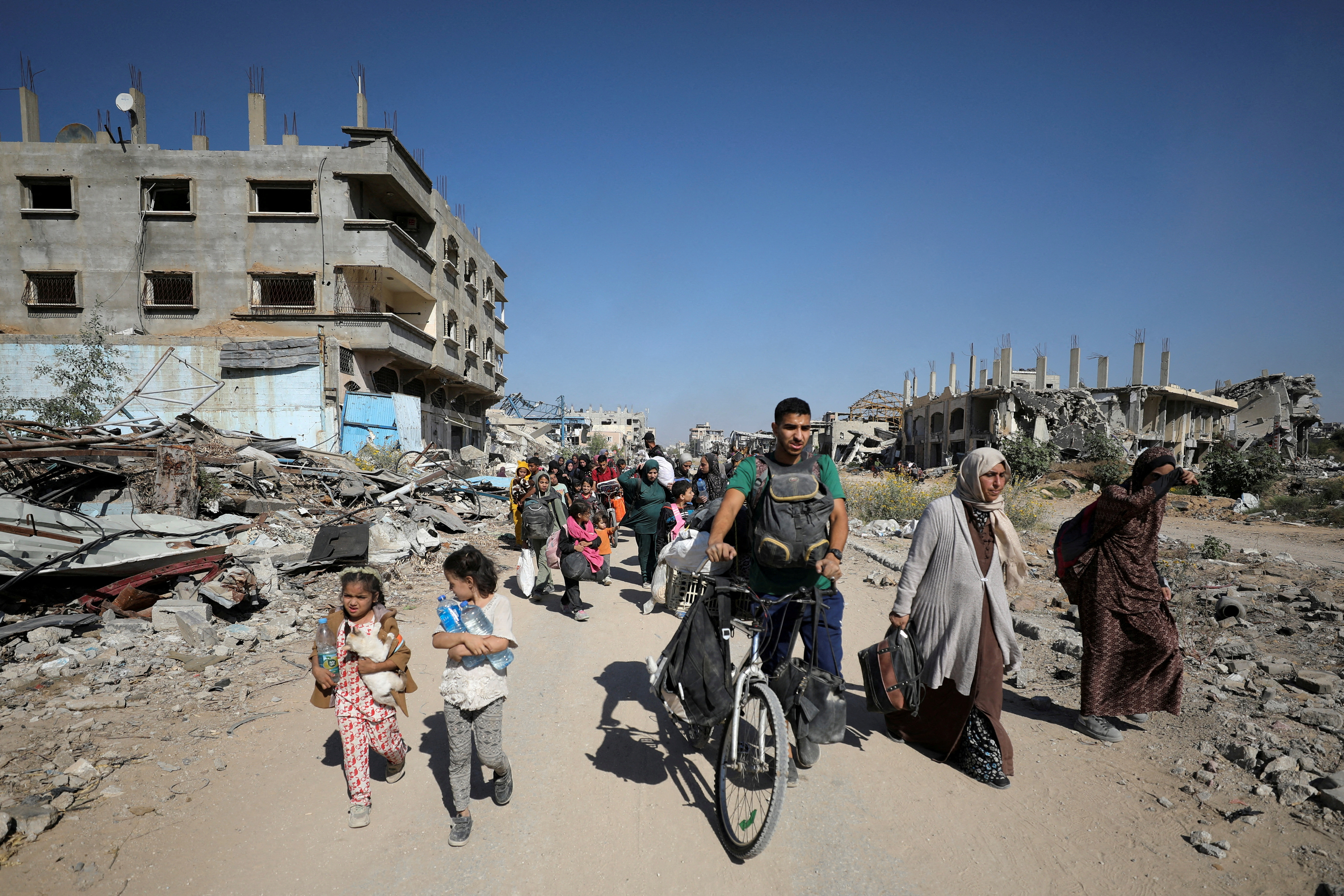 FILE PHOTO: Displaced Palestinians flee the northern part of Gaza amid an Israeli military operation, in Jabalia in the northern Gaza Strip