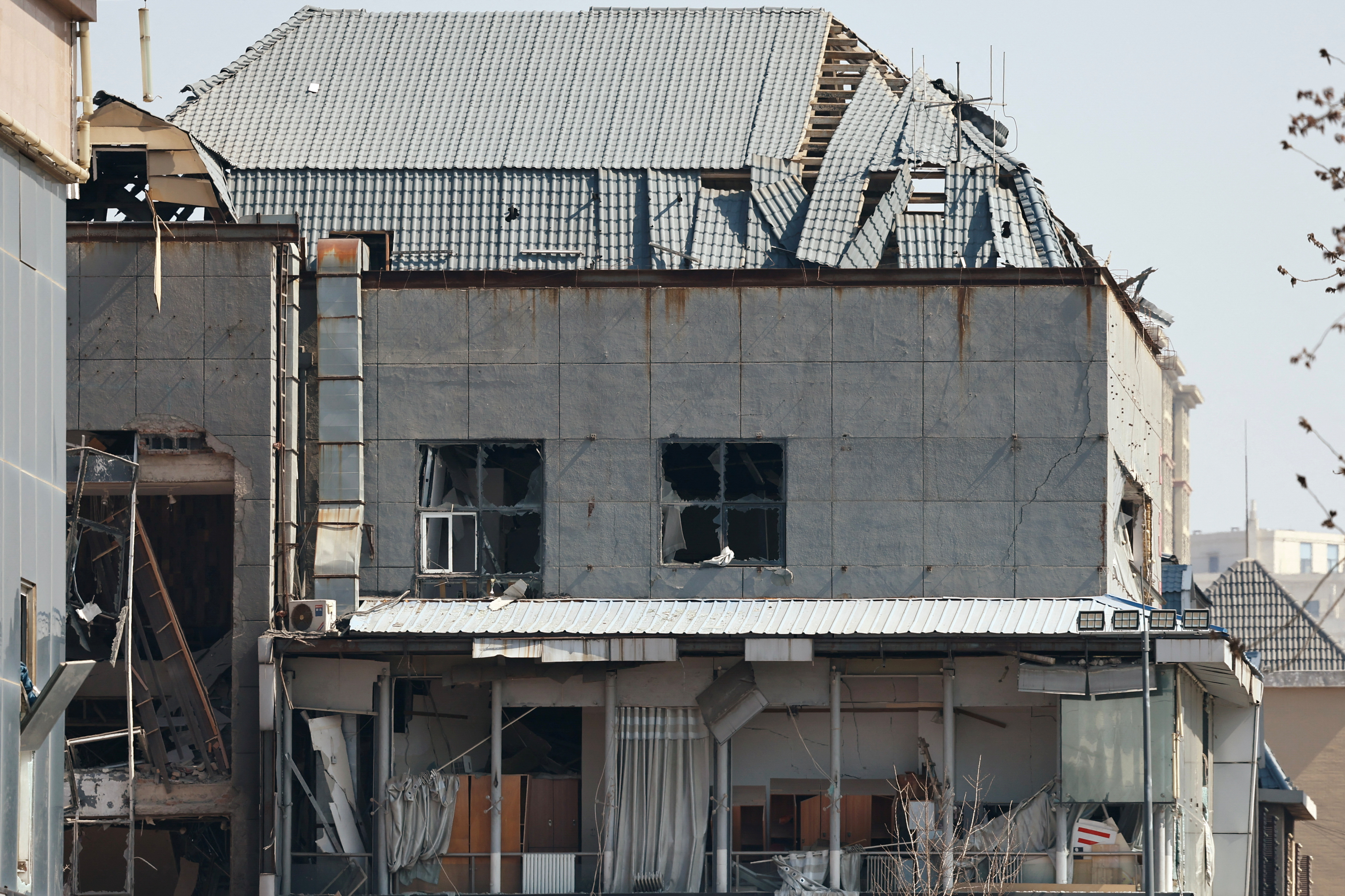 A view of a damaged building at the site of a restaurant blast in Sanhe