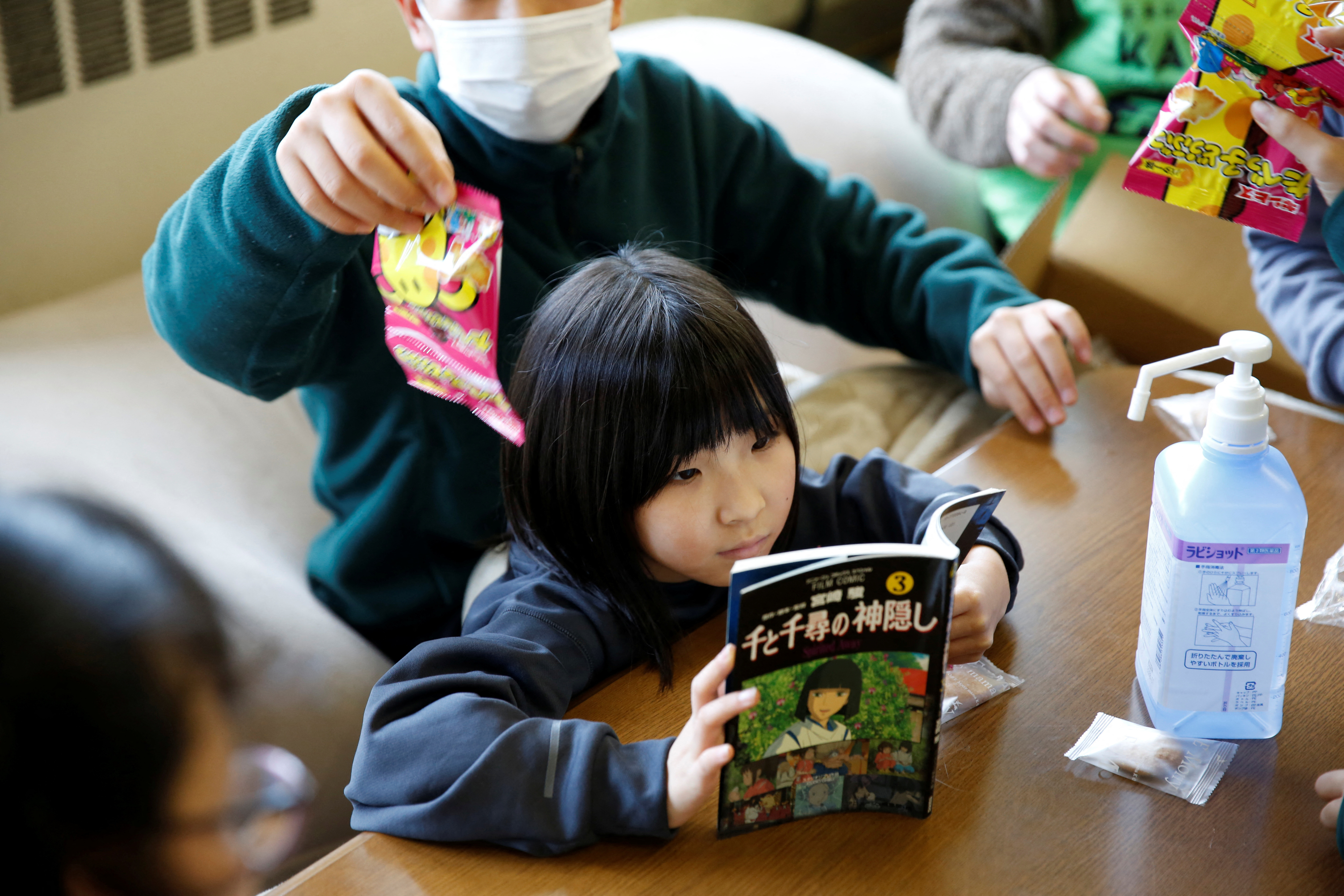 Kanako Yasukawa and her eight-year-old daughter take part in a game at a children’s play space open for survivors of the earthquake in Suzu