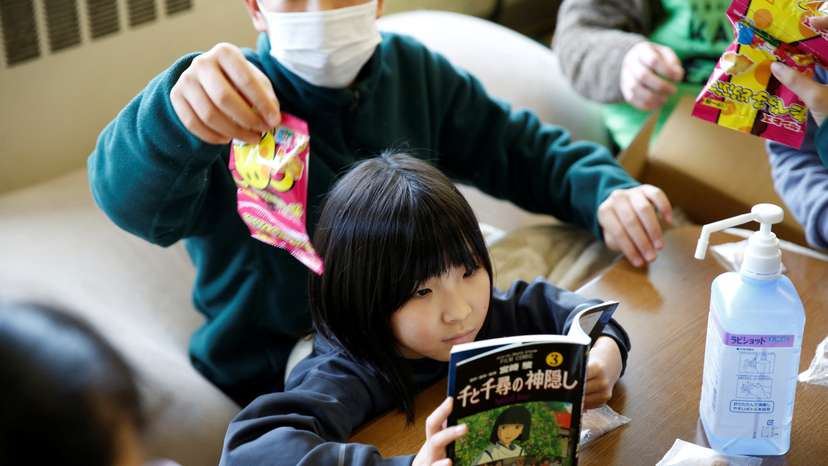 Kanako Yasukawa and her eight-year-old daughter take part in a game at a children’s play space open for survivors of the earthquake in Suzu