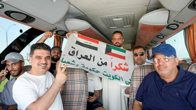 Iraqi fans gather in a bus before it heads to Kuwait, in Basra