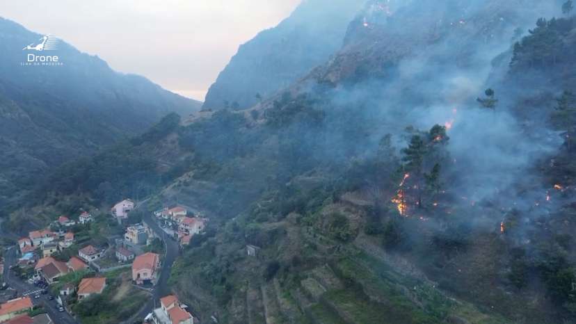 A drone view shows smoke rising as vegetation burns amid a wildfire in the municipality of Ribeira Brava