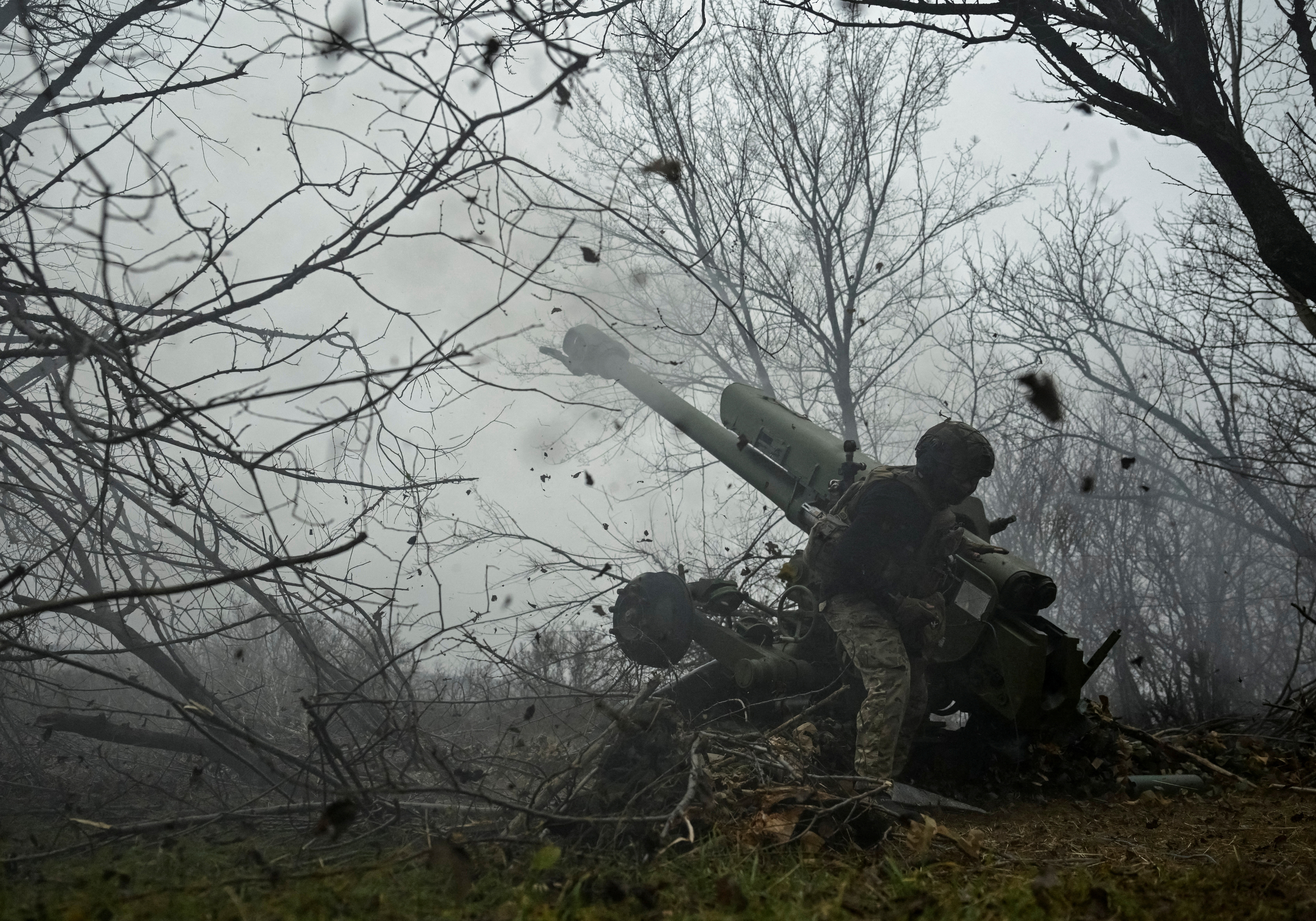 A serviceman fires a howitzer towards Russian troops at a position in a front line in Zaporizhzhia region