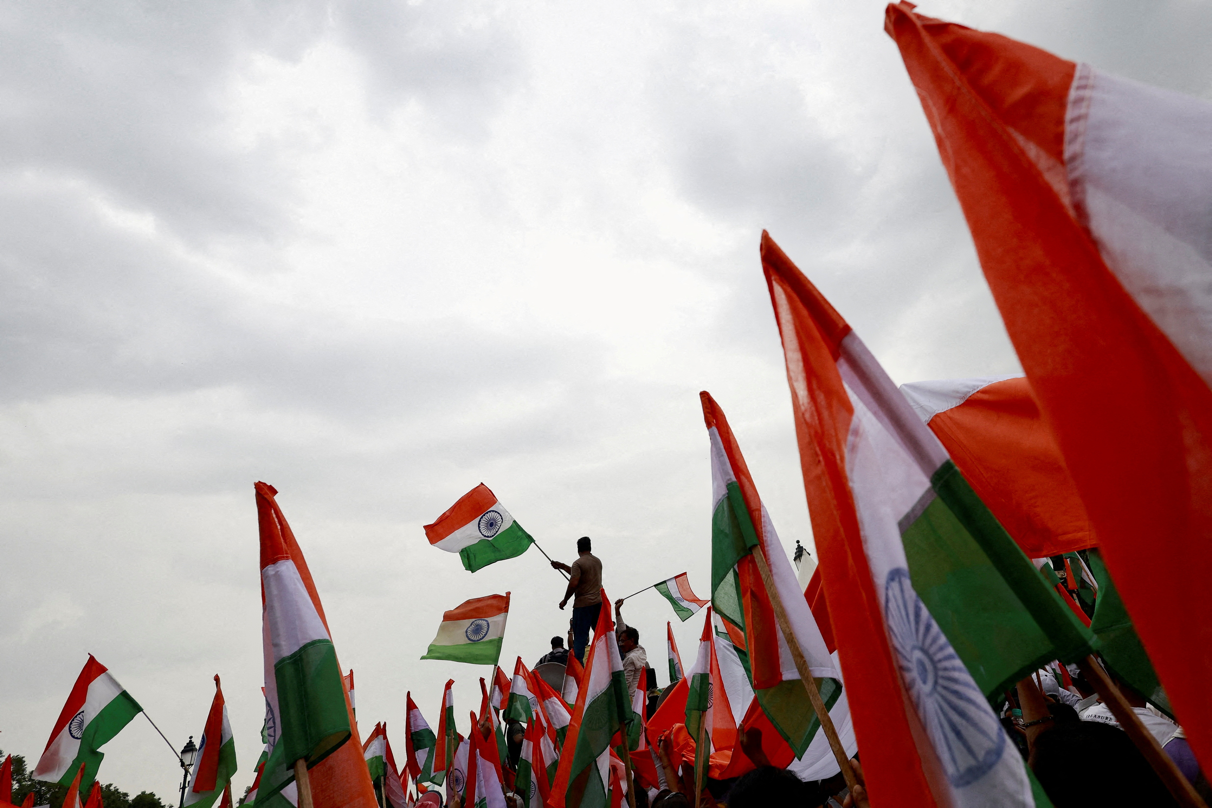 FILE PHOTO: People wave Indian flags in support of the Indian Armed Forces, following the ceasefire announcement between India and Pakistan, in Delhi