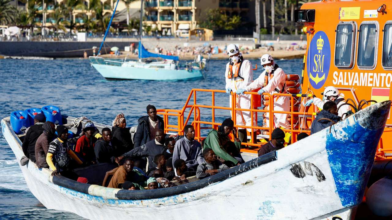 FILE PHOTO: A Spanish Coast Guard vessel tows a fibreglass boat with migrants onboard to the port of Arguineguin, on the island of Gran Canaria