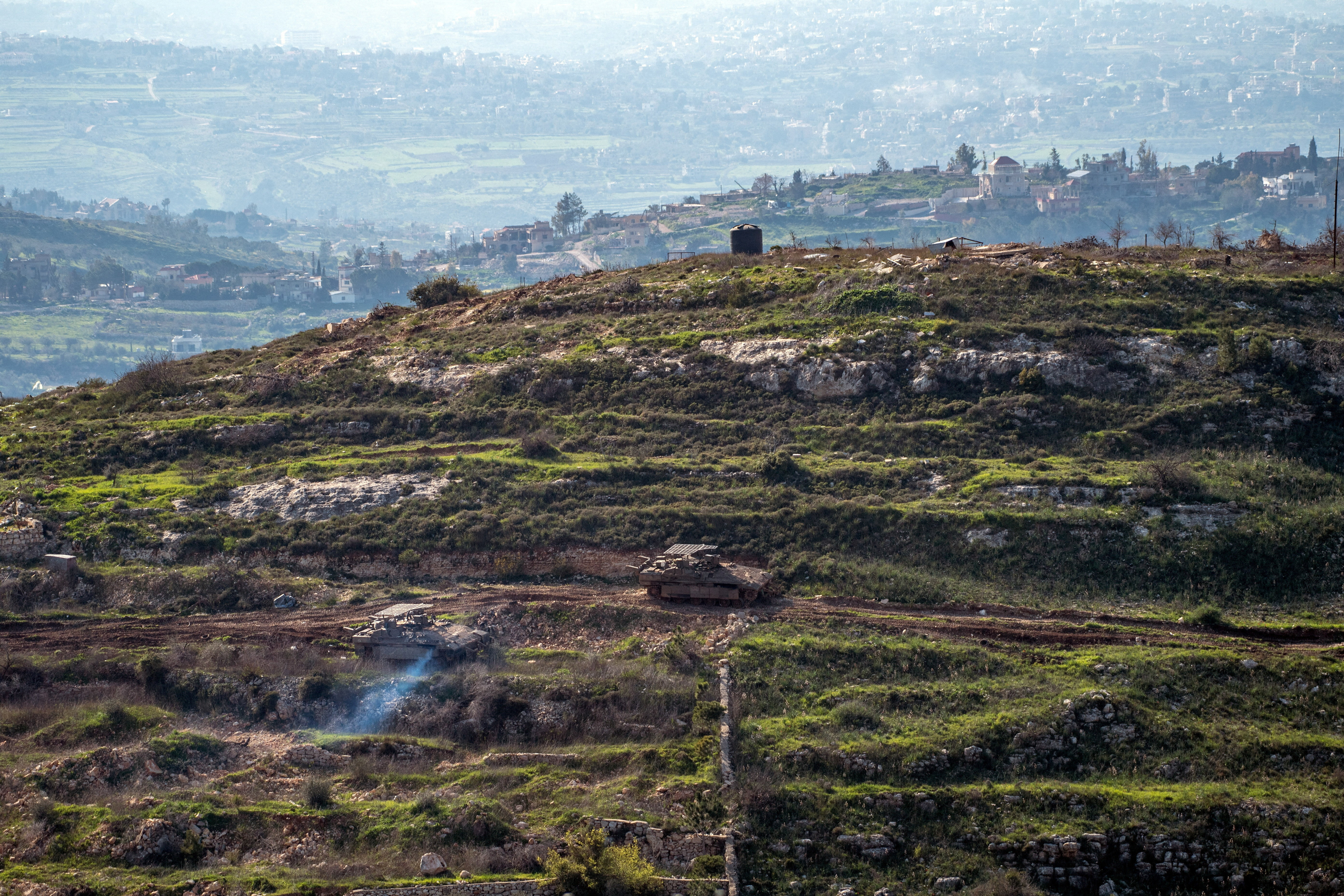 Israeli tanks drive on the Lebaness side of the Israel Lebanon border as seen from Israel, following an escalation between Hezbollah and Israel amid the U.S.-Israeli conflict with Iran