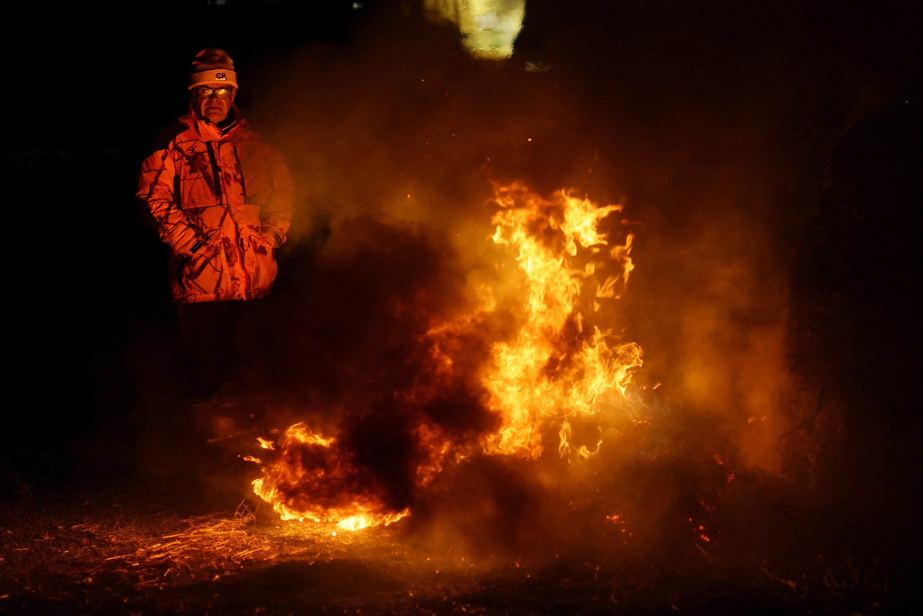 Farmers gather near a farm where a case of lumpy skin disease is suspected in Benque