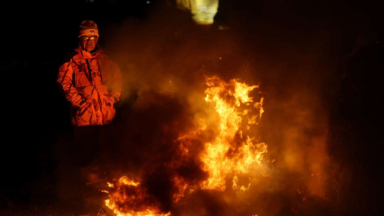 Farmers gather near a farm where a case of lumpy skin disease is suspected in Benque