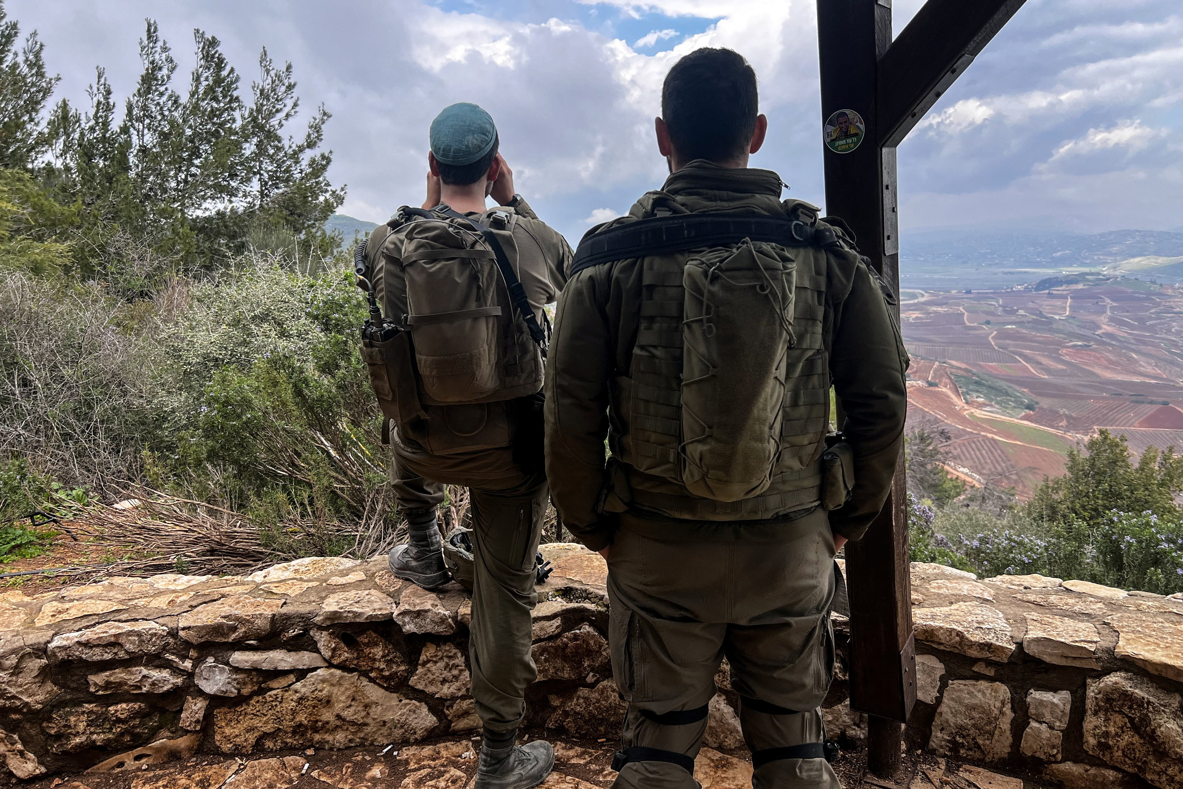 Israeli soldiers look towards Lebanon, amid an escalation between Iran-backed Hezbollah and Israel, by the Israel-Lebanon border