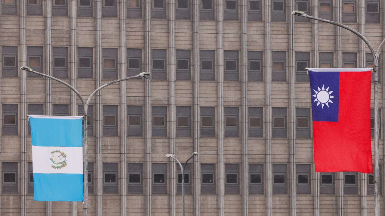 The national flags of Taiwan and Guatemala flutter outside the Presidential Office Building in Taipei