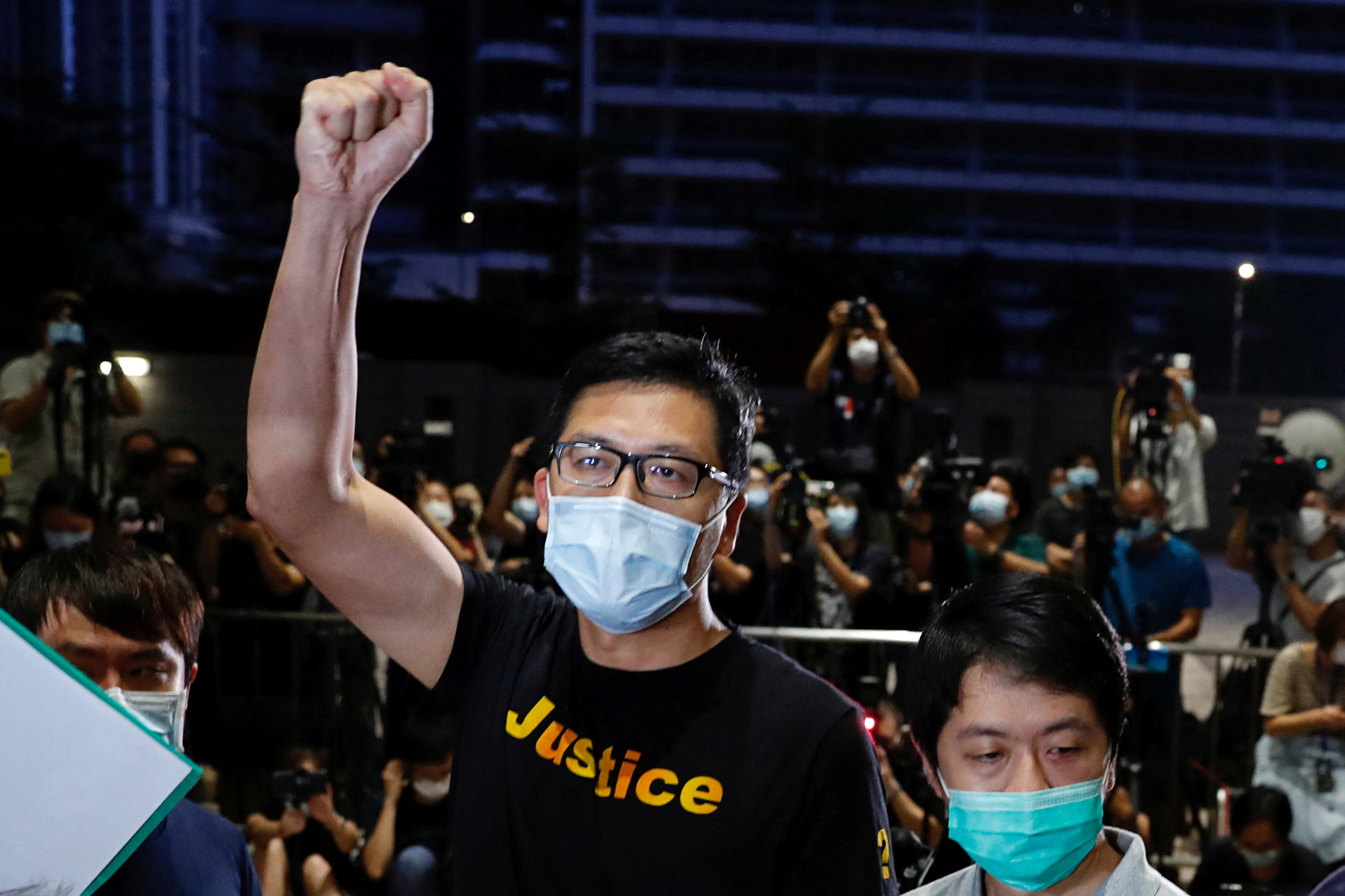 FILE PHOTO: Democratic Party lawmakers Lam Cheuk-ting and Ted Hui Chi-fung reacts after being released on bail over anti-government protests in July last year at West Kowloon Magistrates' Courts, in Hong Kong