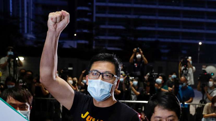 FILE PHOTO: Democratic Party lawmakers Lam Cheuk-ting and Ted Hui Chi-fung reacts after being released on bail over anti-government protests in July last year at West Kowloon Magistrates' Courts, in Hong Kong