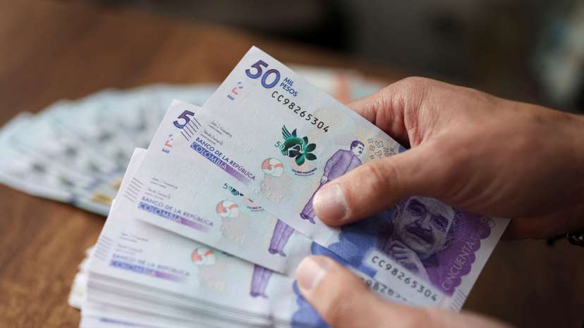 An employee counts Colombian pesos in an exchange house, in Bogota