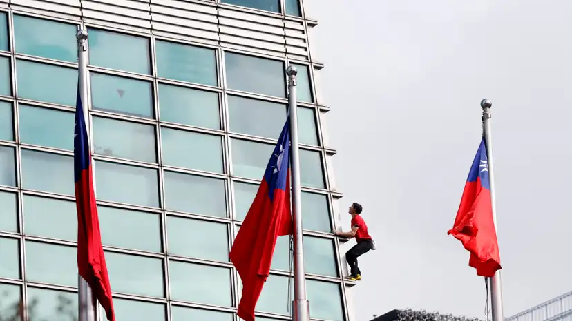 Climber Alex Honnold free soloing Taipei 101 Skyscraper