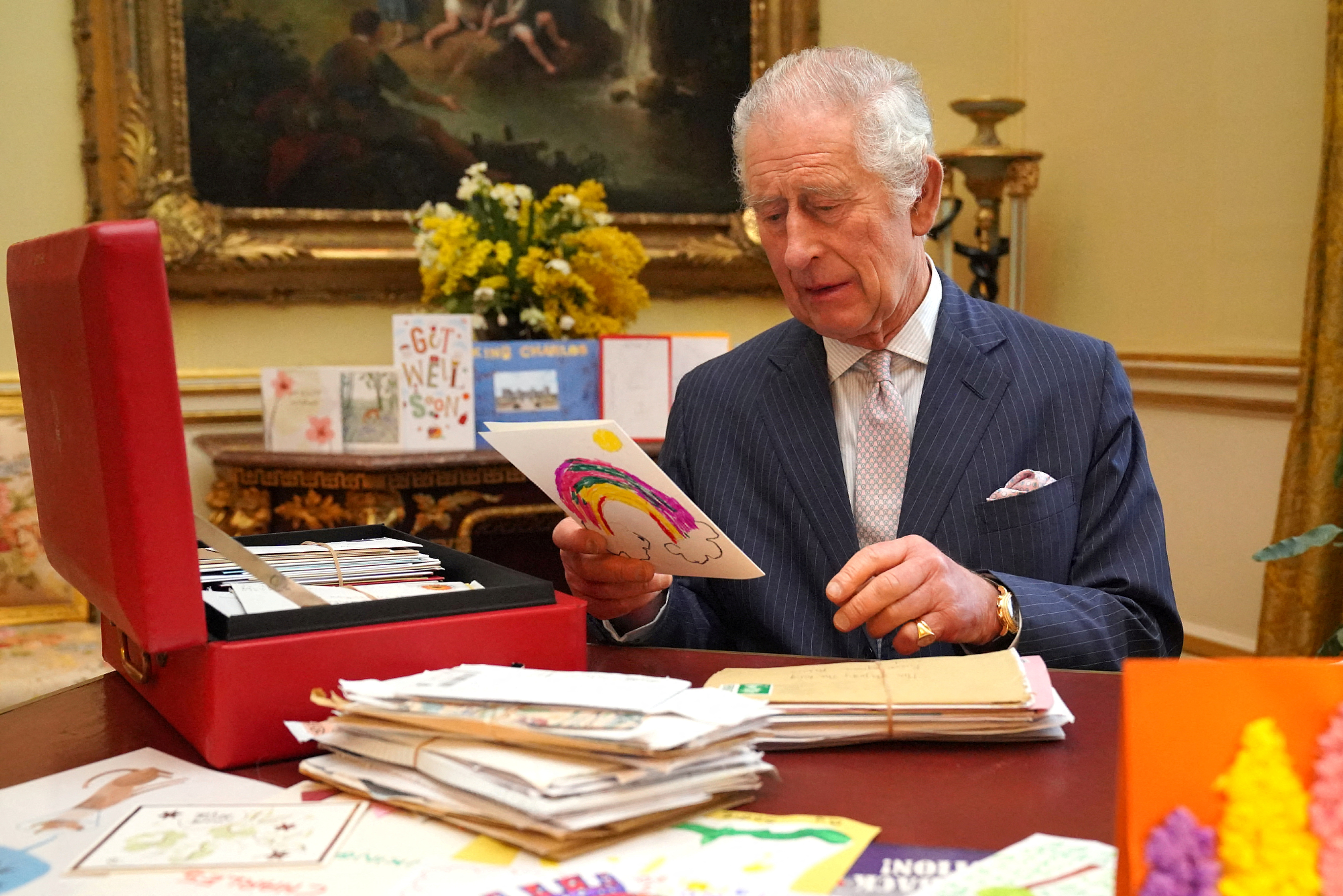 FILE PHOTO: Britain's King Charles reads cards and message, in London