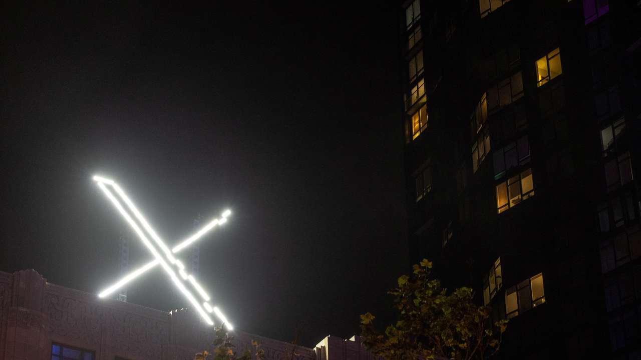 'X' logo is seen on the top of the messaging platform X, formerly known as Twitter