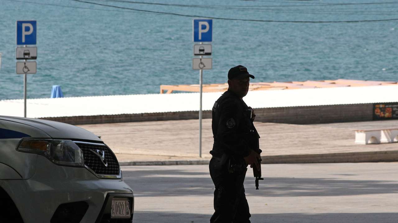 A police officer stands guard near a beach in Sevastopol
