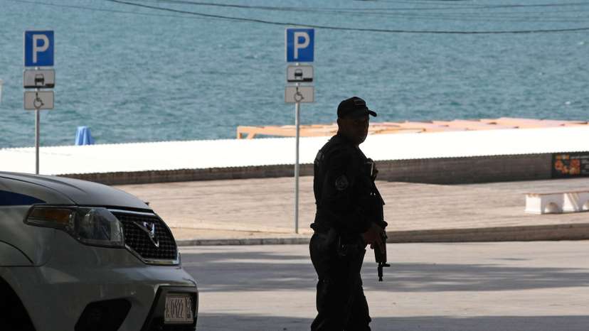 A police officer stands guard near a beach in Sevastopol