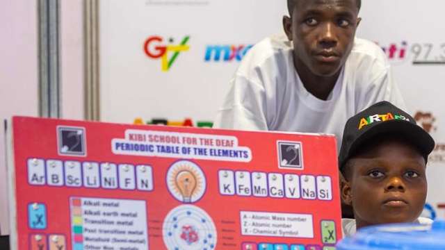 Mawuli and Thomas in their booth at the Robotics Competition in Accra