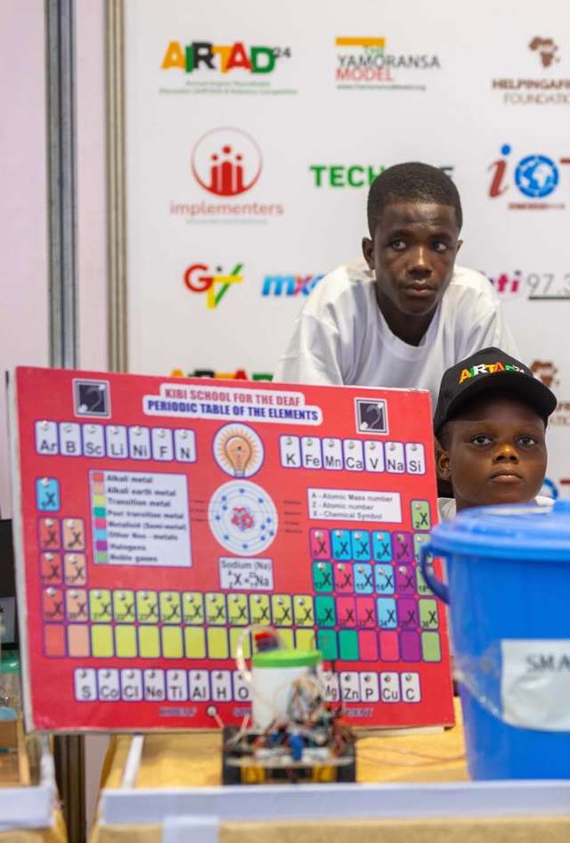 Mawuli and Thomas in their booth at the Robotics Competition in Accra