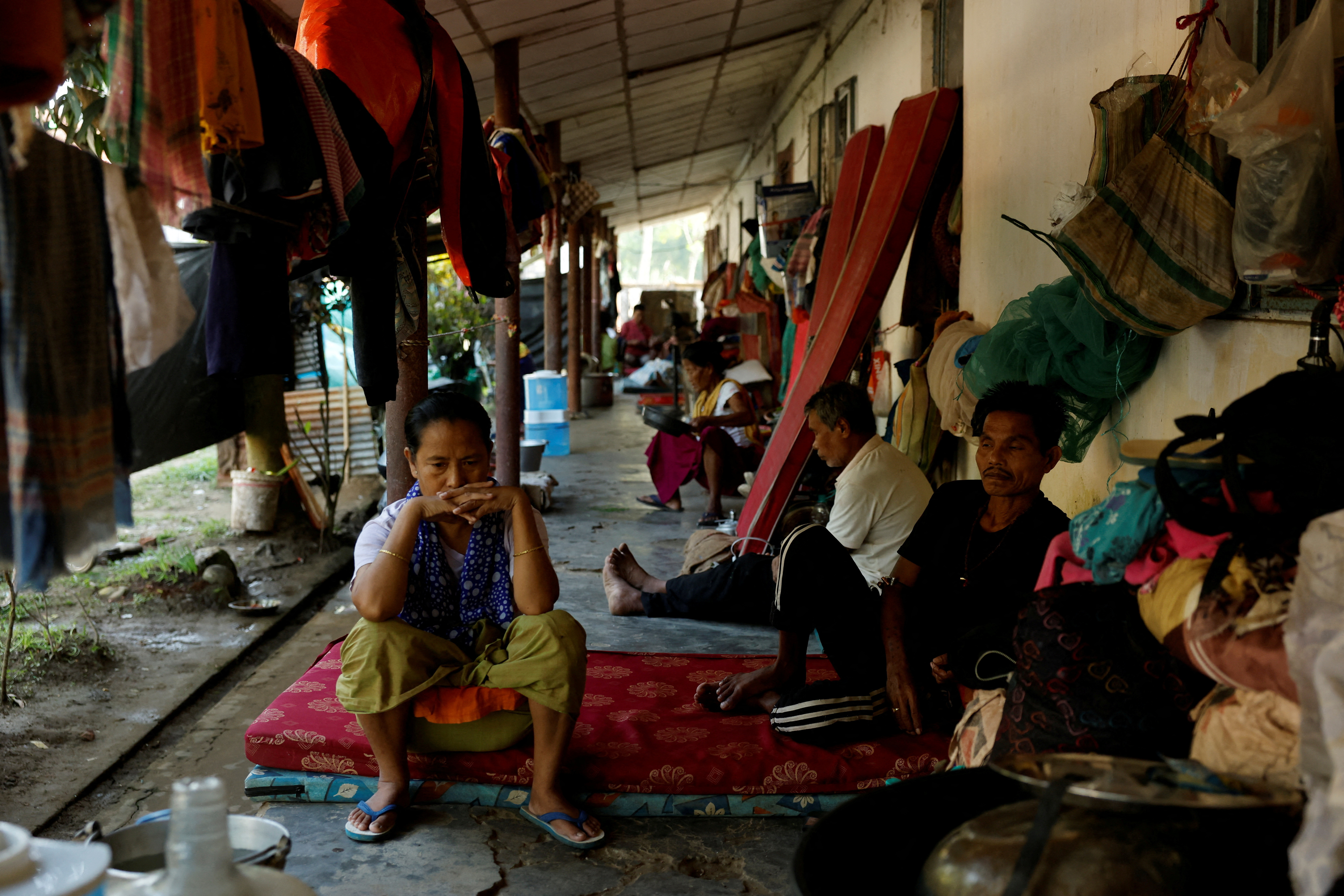 FILE PHOTO: People sit inside a relief camp for displaced Meiteis after their homes and shops were set ablaze, in Borobekra