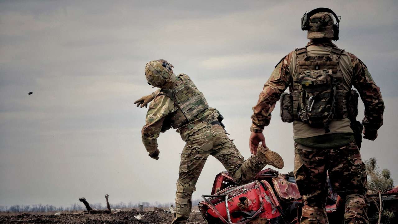 FILE PHOTO: Ukrainian serviceman throws a grenade during a training in Donbas region