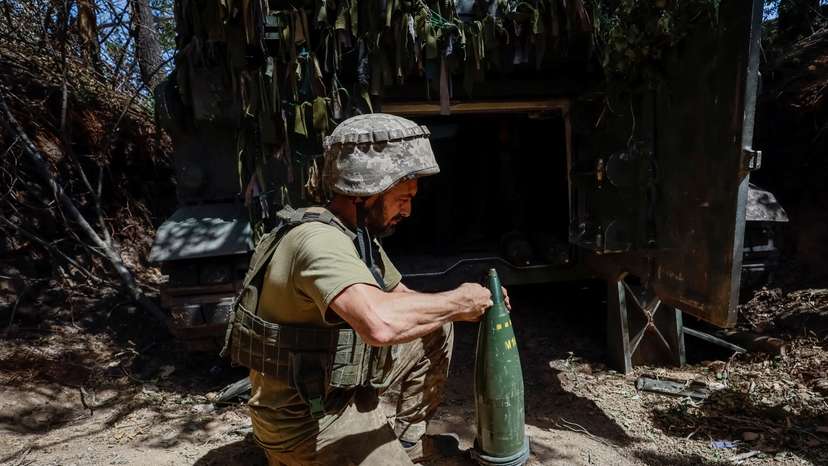 FILE PHOTO: Ukrainian serviceman prepares a shell for an M109L self-propelled howitzer before firing towards Russian troops near a front line, in Donetsk region