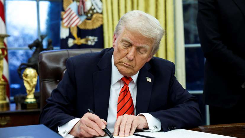 U.S. President Donald Trump signs an executive order in the Oval Office of the White House in Washington