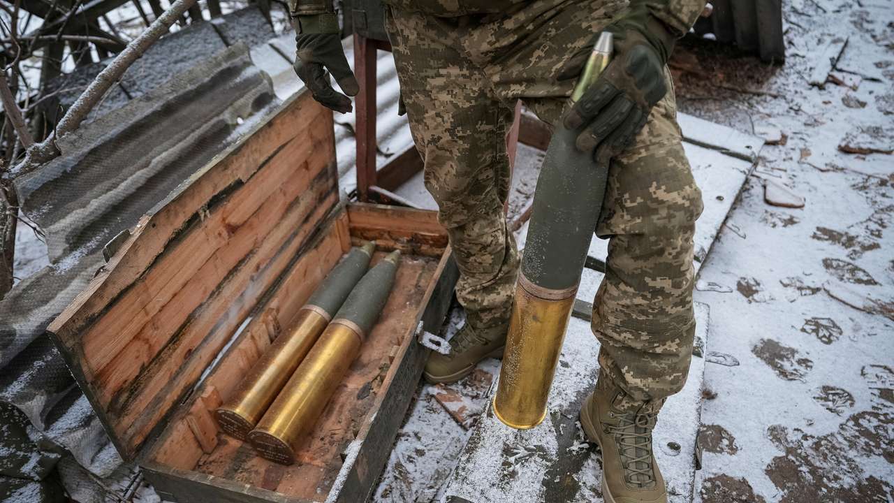 FILE PHOTO: Ukrainian serviceman prepares shells to fire a L119 howitzer towards Russian at a position near Bakhmut