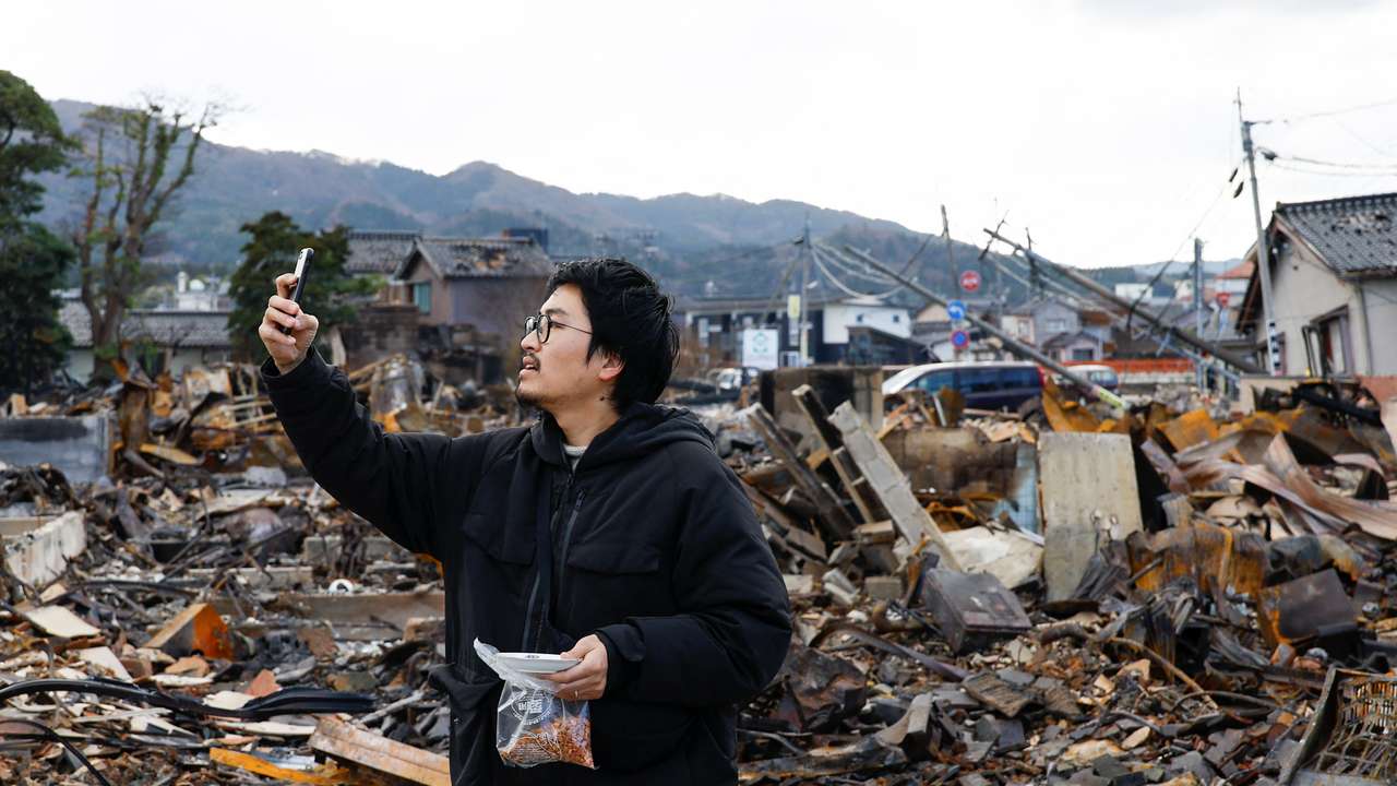 Japanese lacquer artist Kohei Kirimoto searches for his cats, in the aftermath of an earthquake, in Wajima