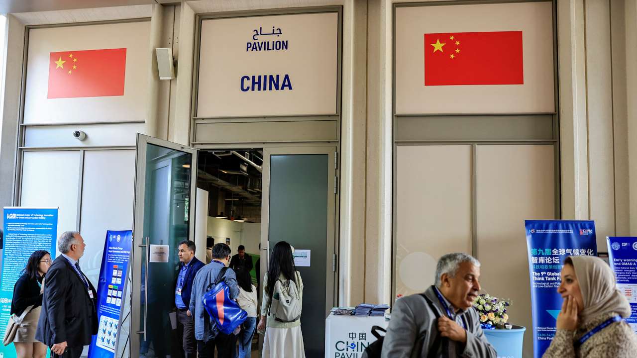 People stand outside the China Pavilion at the United Nations Climate Change Conference COP28 in Dubai