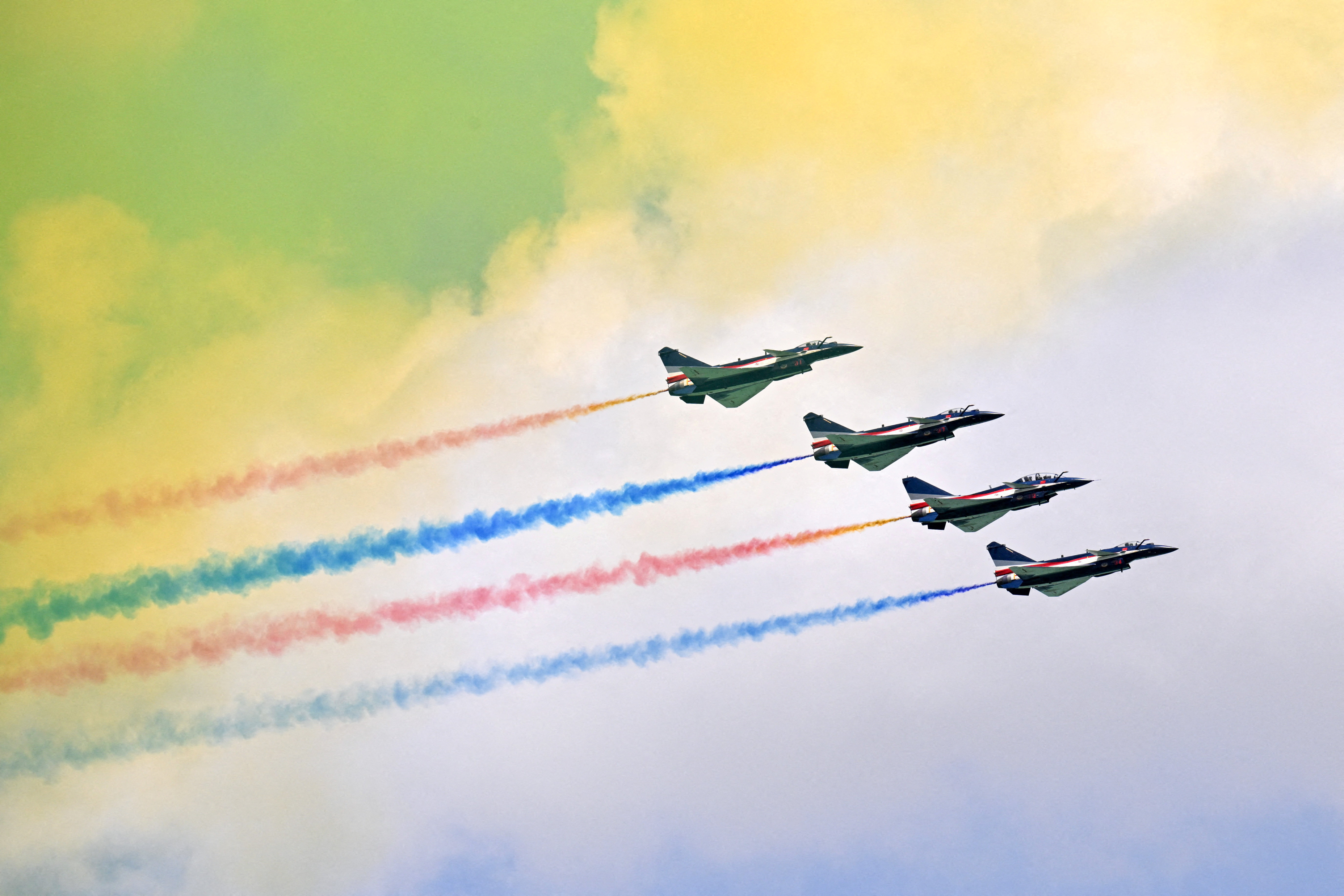 FILE PHOTO: The People's Liberation Army Air Force Bayi Aerobatic Team perform during an aerial flying display at the Singapore Airshow at Changi Exhibition Centre in Singapore
