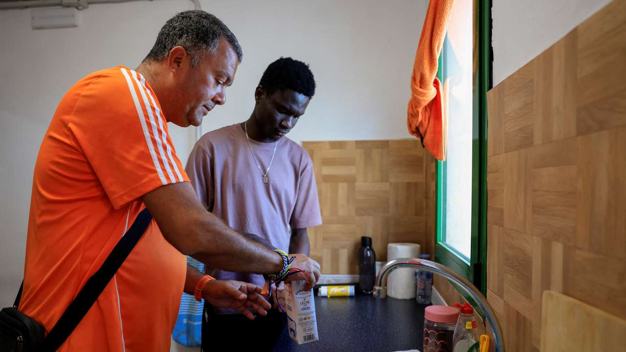 Francis Mendoza and the young Gambian migrant Omar Kebbeh, 18, prepare coffee in the house where Kebbeh has been welcomed in Frontera on the island of El Hierro
