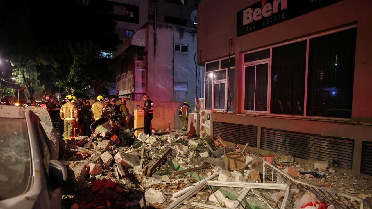 Emergency personnel inspect damage in a building following an Iranian projectile strike, amid the U.S.-Israeli conflict with Iran, in Ramat Gan