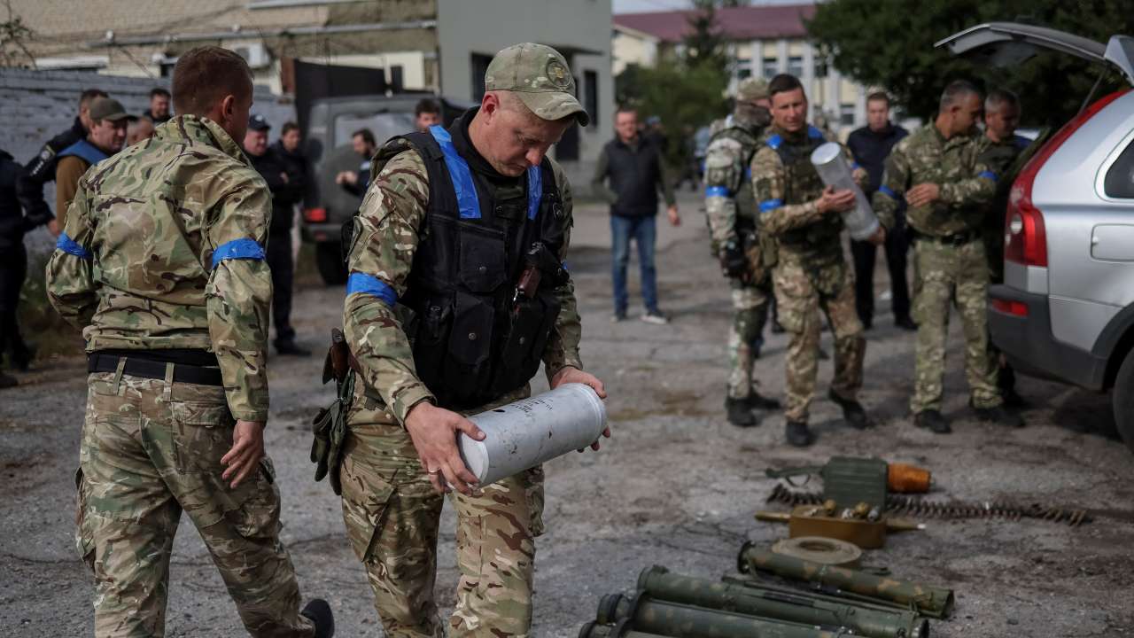 FILE PHOTO: A police sapper carries a cassette with anti-personnel mines POM-3 after return from the village of Udy, recently liberated by Ukrainian Armed Forces, in the town of Zolochiv