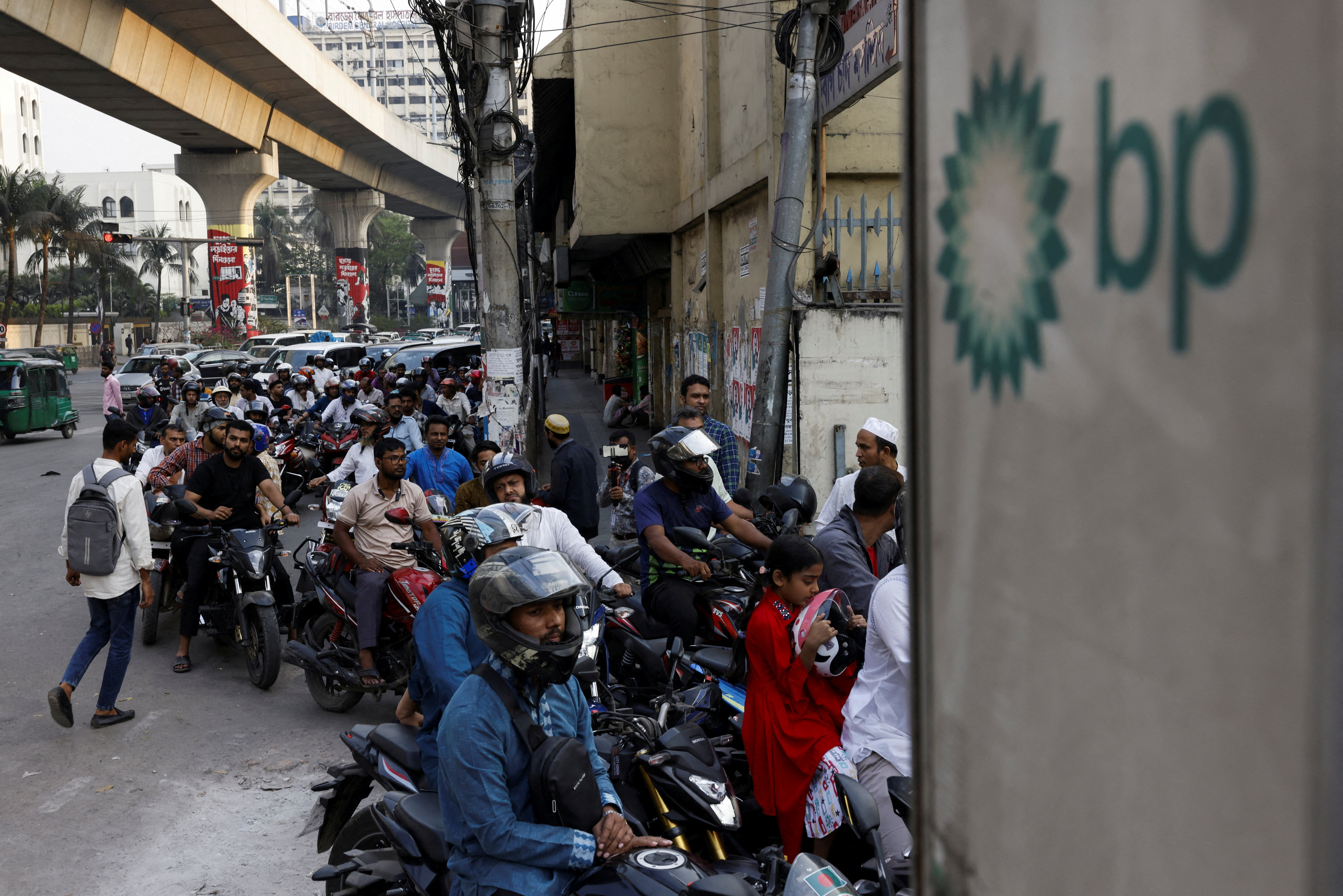 FILE PHOTO: Vehicles queue at a fuel station, as concerns grow over fuel supplies following U.S.-Israel conflict with Iran, in Dhaka